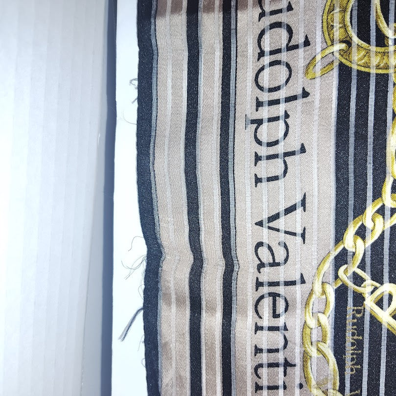 This is a Rudolph Valentino silk scarf with a black and gold chain pattern. #11