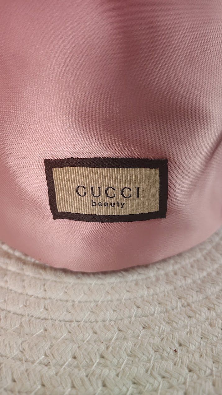 Gucci Beauty Novelty small drawstring pouch in pink satin with a floral interior lining.  GWP