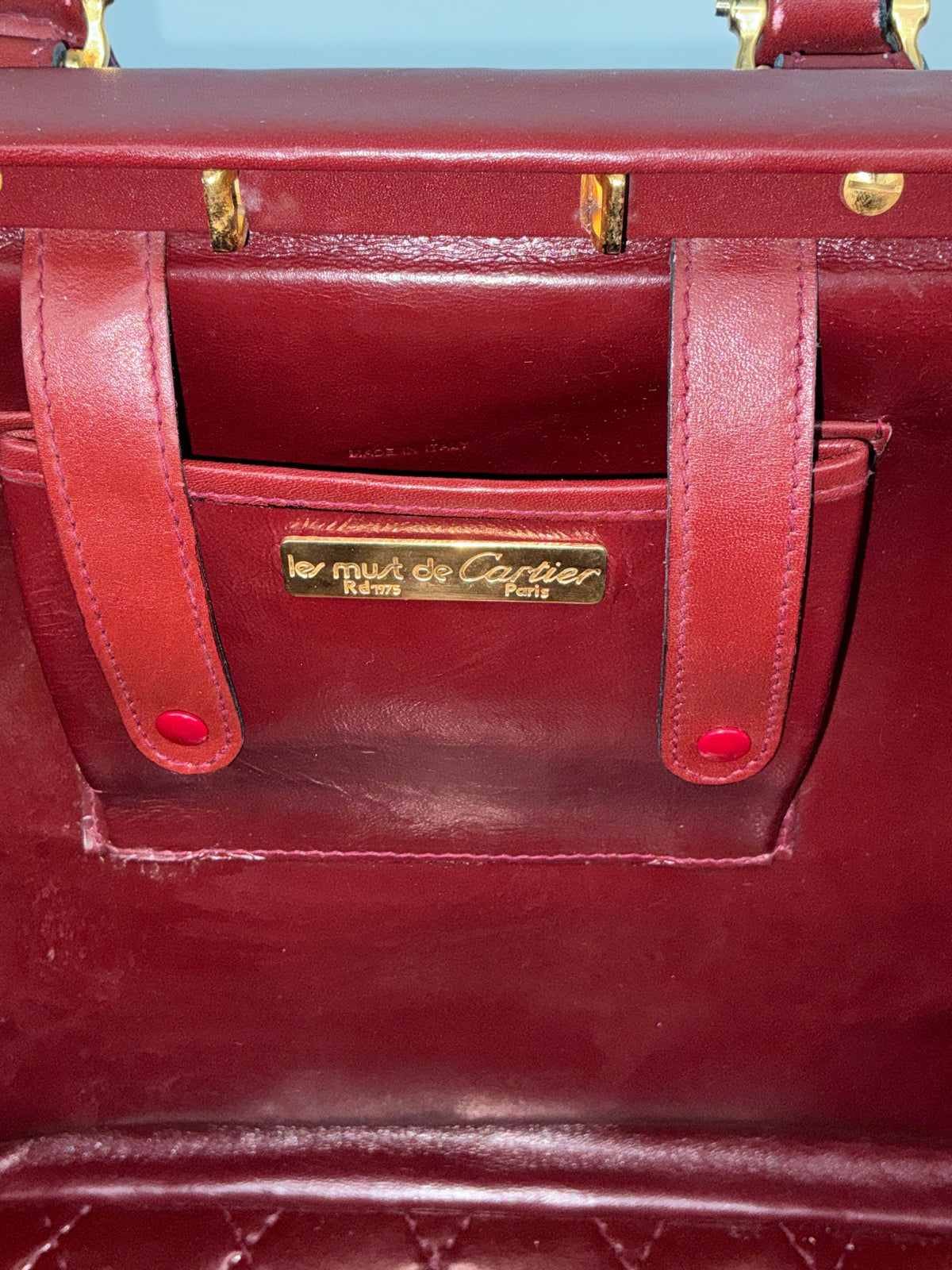 House of Melton vintage Les Must de Cartier bordeaux suede doctor bag interior with gold logo plaque and leather trim