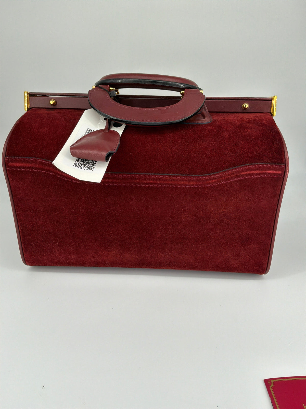 House of Melton vintage Les Must de Cartier bordeaux suede doctor travel bag with gold hardware and original retail tag.